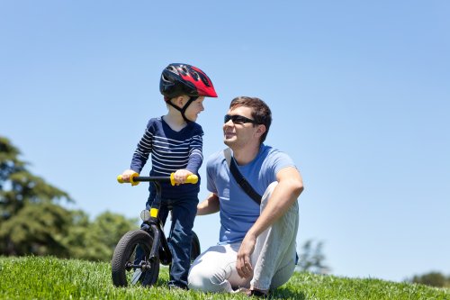 Hình ảnh mỉm cười hạnh phúc của cha với con trai trên một chiếc xe đạp